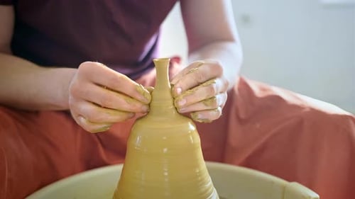 Potier expérimenté créant un vase en argile à l'aide d'outils professionnels