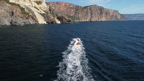 Jet Ski Tows Raft in Beautiful Coastal Waters