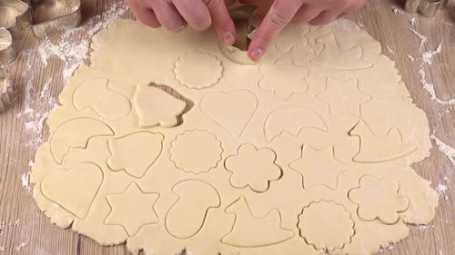 Cutting Cookie Dough with Christmas Cookie Cutters