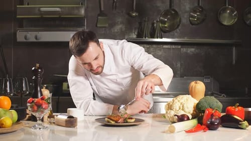 Chef Garnishing Dish with Professional Precision in Kitchen