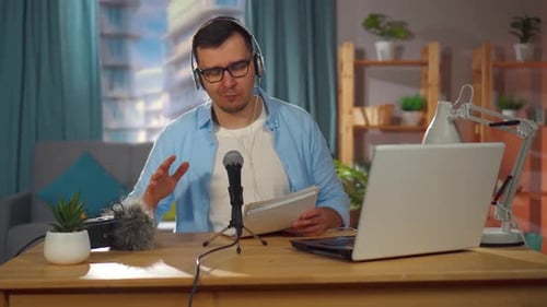 Man Records an Audio Podcast or Conducts an Internet Stream While Sitting at Home