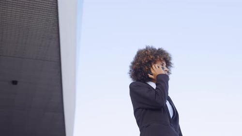 Young Woman Talking on Cell Phone Outside Office