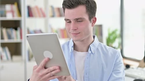 Young Man Using Tablet Indoors