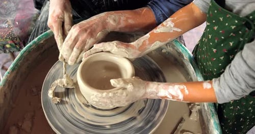 Hands Shaping Clay on Pottery Wheel