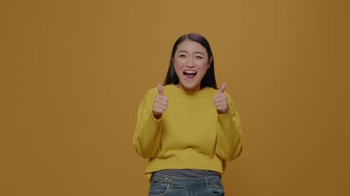 Enthusiastic Woman Giving Two Thumbs Up