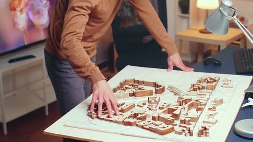 Successful Architect Working at Night Time in His Home Office