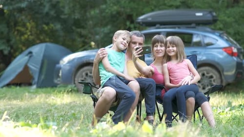 Happy Family Enjoying Camping Outdoors Together