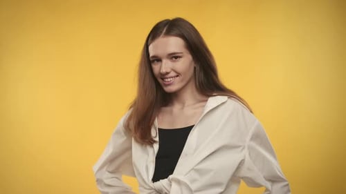 Smiling Brunette Woman in White Shirt Posing