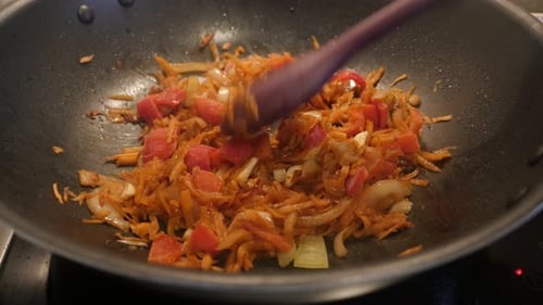 Vegetable mix frying in hot oil 4K 2160p 30fps UltraHD footage - Close-up preparing of bulb onion an