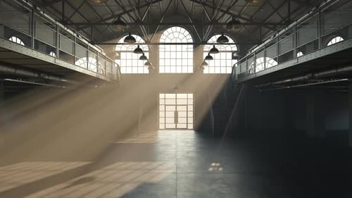 Loft hall interior illuminated by a beam of sunlight entering through windows.