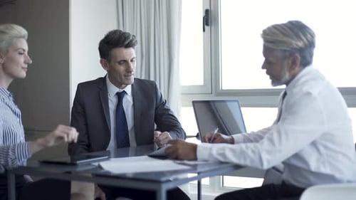 Business people signing document in office