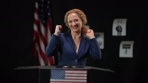 Woman Celebrates Victory at Podium with US Flag