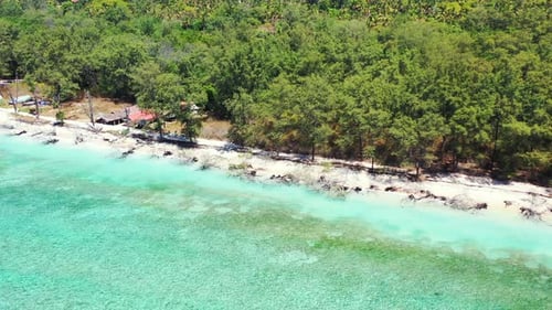Daytime above travel shot of a sandy white paradise beach and blue water background in colorful 4K
