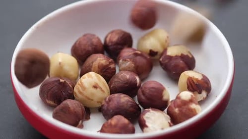 Slow Motion of Dropping Hazelnuts in a Container