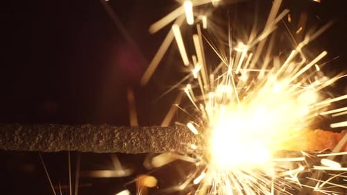 Burning Sparkler Emitting Golden Festive Sparks