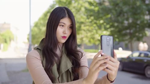 Young Asian Woman Takes Selfies Smartphone Apartment Building Complex Background