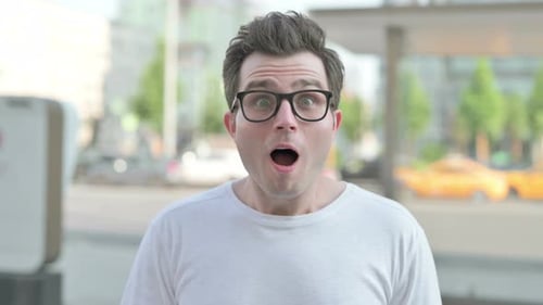 Excited Man Celebrates Success in Urban Setting