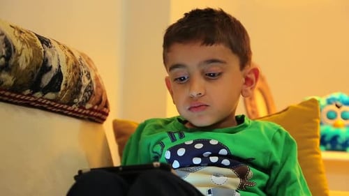 Child Eating while Watching Tablet Device at Home