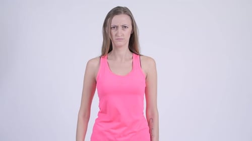 Woman Gives Thumbs Down with Frown Expression