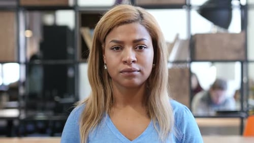 Young Adult Woman Looking at Camera, Office Setting
