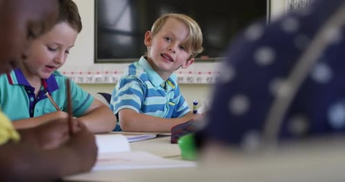 Young Children Sitting at School Desks