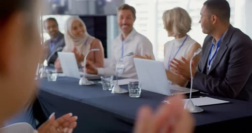 Diverse Panelists Clapping at Business Conference