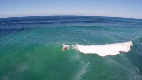 Aerial view of a man sup stand-up paddleboard surfing in Hawaii