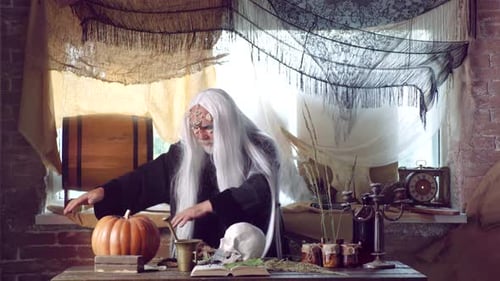 Wizard Casting Spell with Skull and Pumpkin
