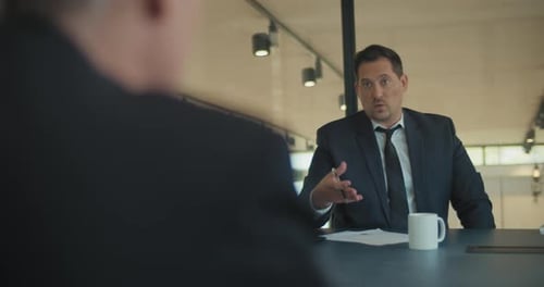 Two businessmen discussing a marketing strategy during a business meeting at the office.