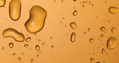 Abstract water drops on gold bronze background, macro