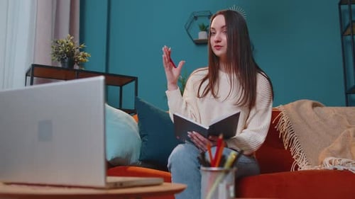 Young Woman Video Conferencing with Laptop at Home