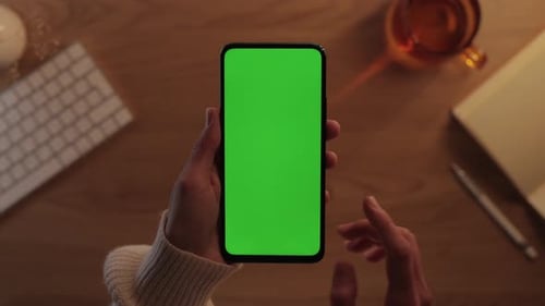 Close Up of Cell Phone with Green Screen in Female Hands