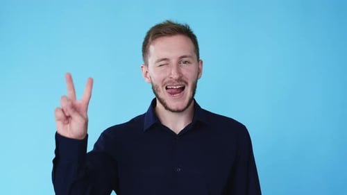 Smiling Young Adult Winking with Peace Sign