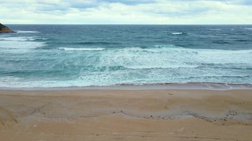 High and powerful waves coming fast to the beach, waves in winter day