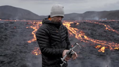 Man Prepares Drone near Active Lava Field