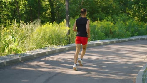 Man Jogging on Rounded Road in Slow Motion