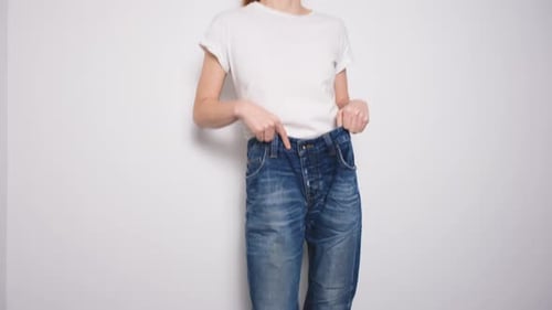 Young Adult Wearing Baggy Blue Jeans and White Tee