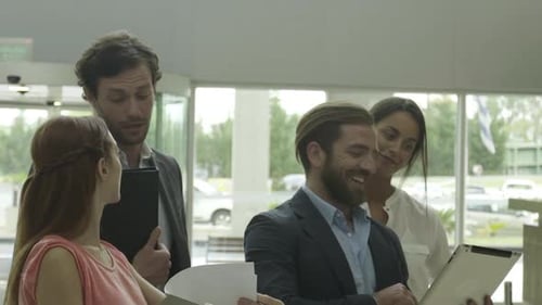 Colleagues working together with digital tablet in office