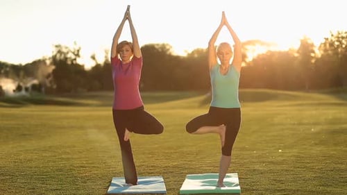 Two Women Practicing Yoga in Rural Setting