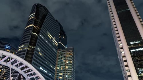 Close-Up Lights of a Skyscrapers at Fast Moving Clouds Background in the Night Time