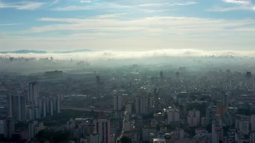 Sweeping Aerial View of a Foggy Cityscape