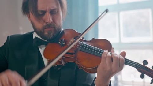 Man Playing Violin in Formal Attire Close Up
