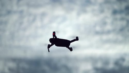 Drone Flying Against Cloudy Sky