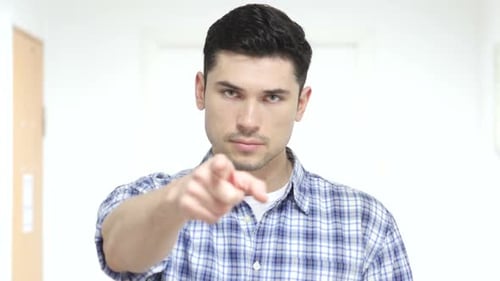 Young Adult Man Points Finger at the Camera