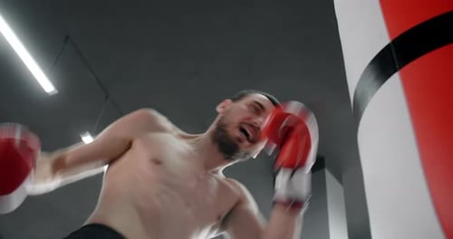 Boxer Man in Red Boxing Gloves Punches Boxer Bag in Slow Motion Training in Boxing Club 60p Prores