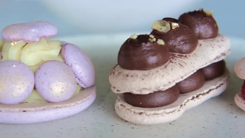 Assorted Decorated Macarons Displayed on White Surface