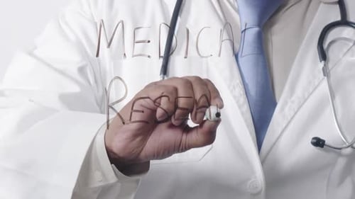 Doctor Writing Medical Research on Glass