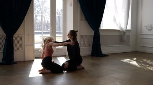 Rehearsing of Two Modern Dancers in Hall Young Man and Woman are Sitting on Floor