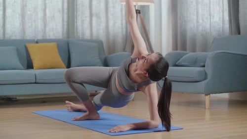 Young Asian Athletic Female Exercising, Stretching And Practicing Yoga At Home. Healthy Lifestyle