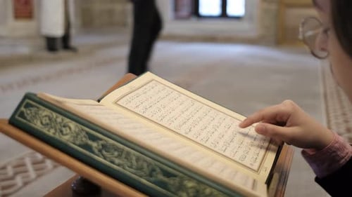 Young Adult Reading Ornate Book Indoors